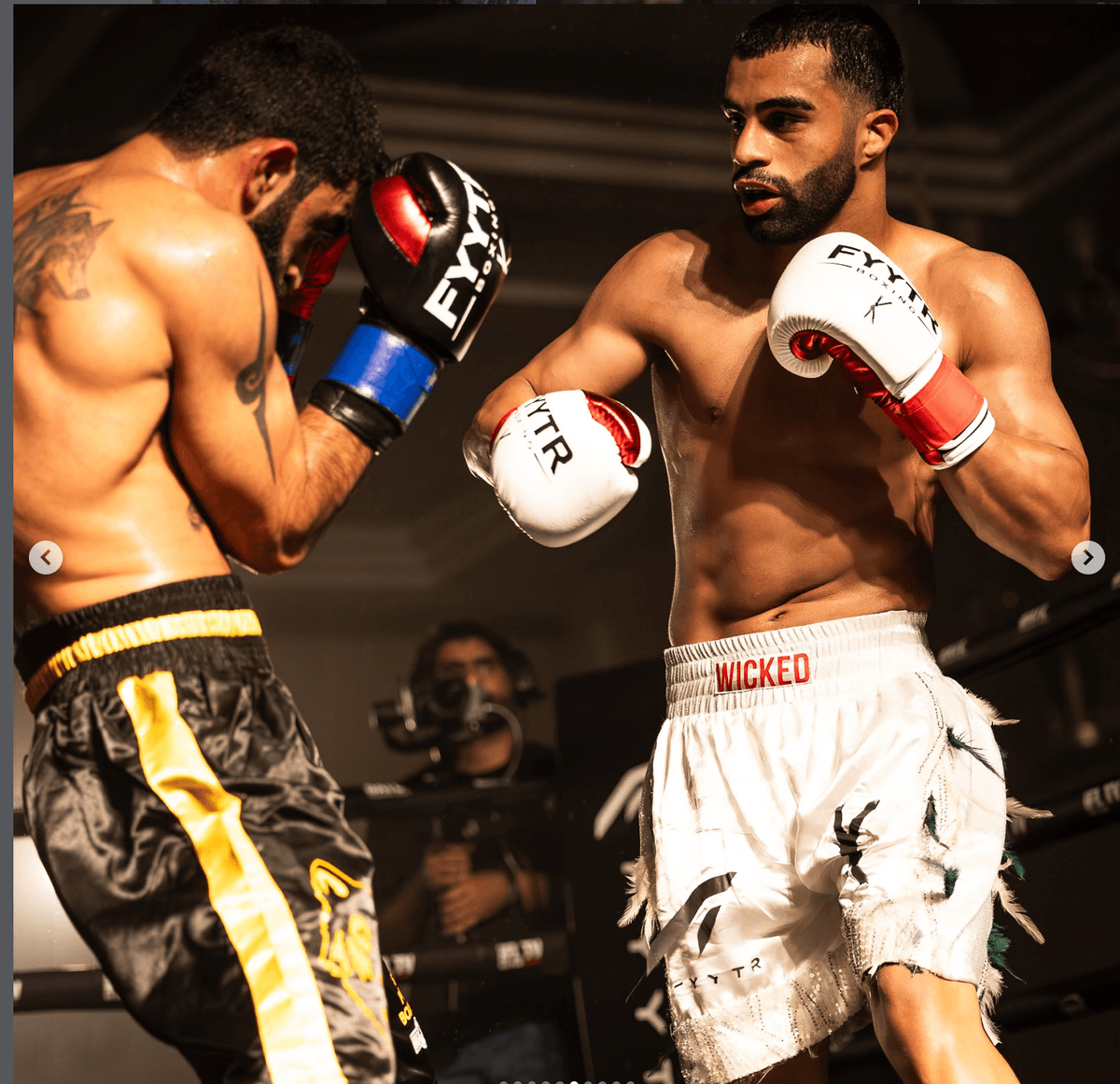 Two boxers exchanging punches at a UAE fight night